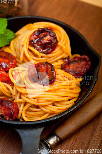 Image of italian spaghetti pasta and tomato with mint leaves 