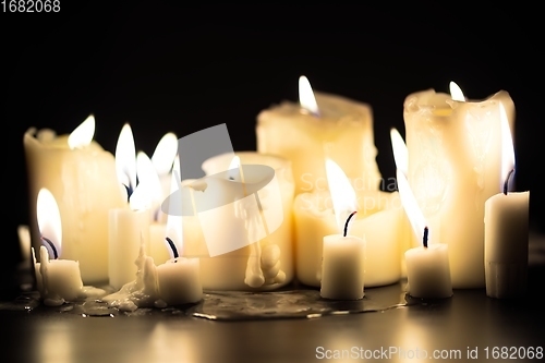 Image of Candles glowing against dark background