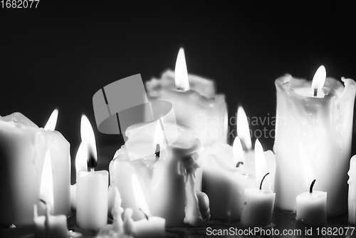 Image of Candles glowing against dark background