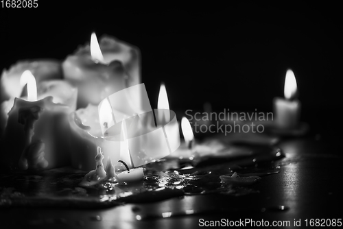 Image of Candles glowing against dark background