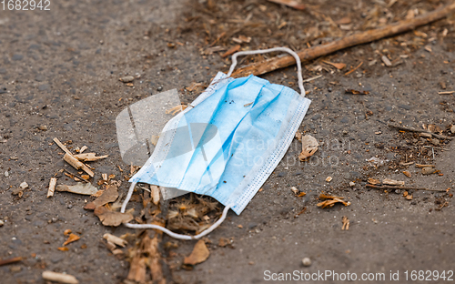 Image of Discarded medical mask on the ground