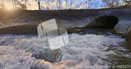 Image of Large sewage tunnel with filth flowing out