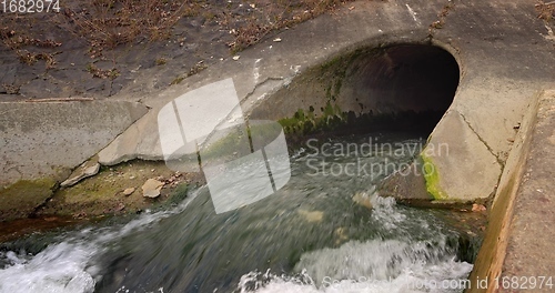 Image of Large sewage tunnel with filth flowing out