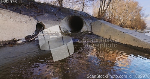 Image of Large sewage tunnel with filth flowing out