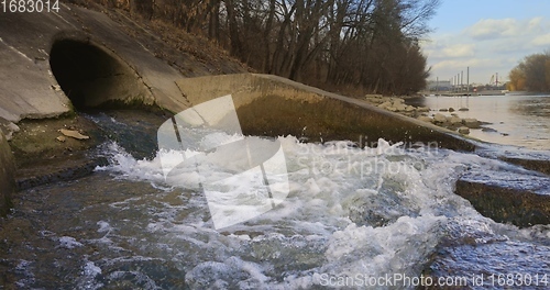 Image of Large sewage tunnel with filth flowing out