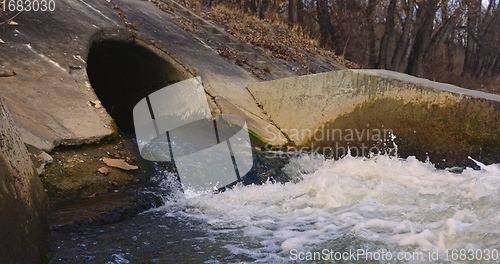 Image of Large sewage tunnel with filth flowing out