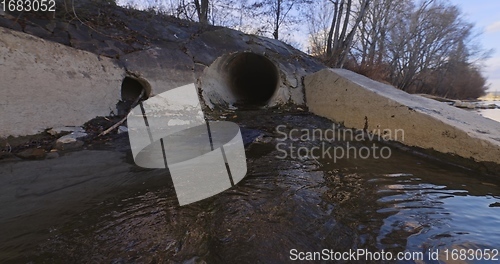 Image of Large sewage tunnel with filth flowing out