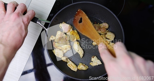 Image of Preparing low fat fried chicken for dinner on induction