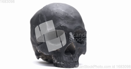 Image of Dark skull rotating against white isolated background