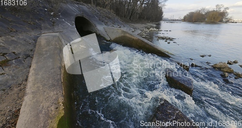 Image of Large sewage tunnel with filth flowing out