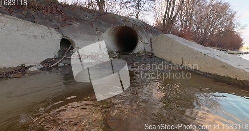 Image of Large sewage tunnel with filth flowing out