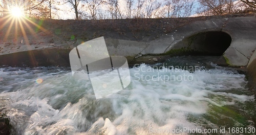 Image of Large sewage tunnel with filth flowing out