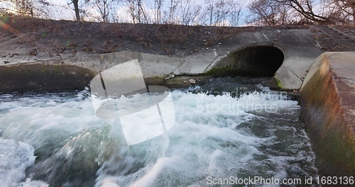 Image of Large sewage tunnel with filth flowing out