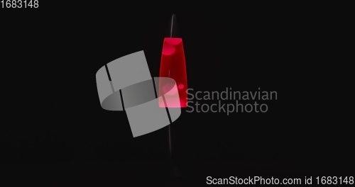 Image of Red lava lamp aginast dark isolated background