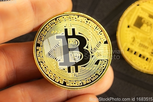 Image of Physical bitcoin held in hands closeup