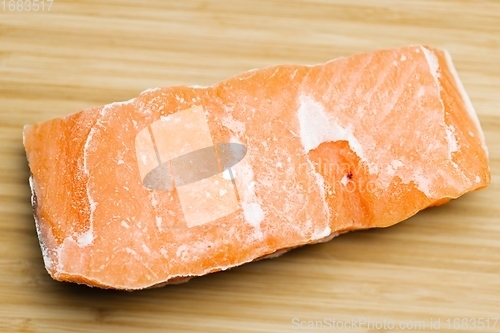 Image of Slice of salmon on the table closeup