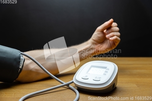 Image of Man measuring blood pressure closeup