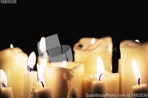 Image of Candles glowing against dark background