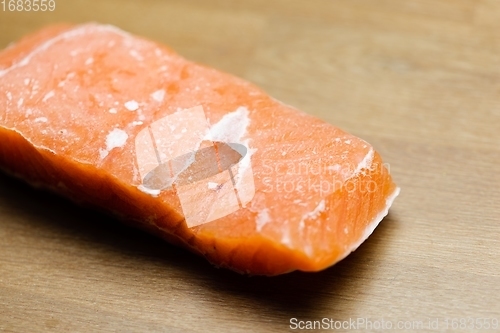 Image of Slice of salmon on the table closeup
