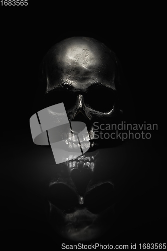 Image of Spooky dark black skull aginast dark background