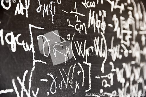 Image of Mathematical formulas on dark black chalk board