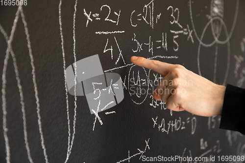 Image of Mathematical formulas on dark black chalk board