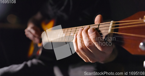 Image of Playing on the guitar closeup footage