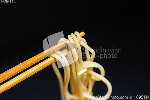 Image of Spaghetti closeup photo on chopsticks