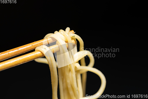 Image of Spaghetti closeup photo on chopsticks