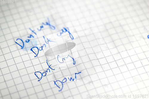 Image of Tears on white paper with do not cry text 