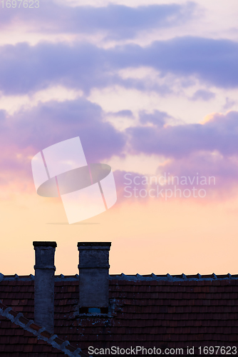 Image of Sky at dawn with chimney and house