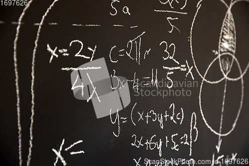 Image of Mathematical formulas on dark black chalk board