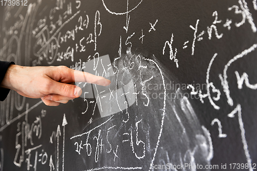 Image of Mathematical formulas on dark black chalk board