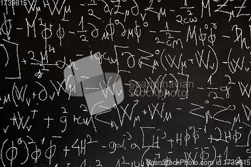 Image of Mathematical formulas on dark black chalk board