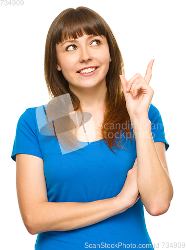 Image of Portrait of a young woman pointing to the right