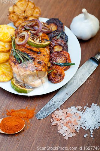 Image of roasted grilled BBQ chicken breast with herbs and spices 