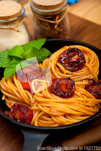 Image of italian spaghetti pasta and tomato with mint leaves 