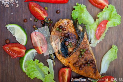 Image of wood fired hoven cooked chicken breast on wood board 