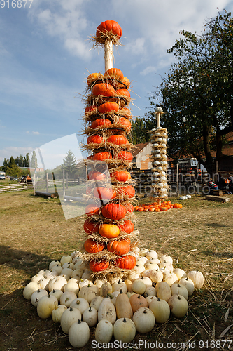 Image of Ripe autumn pumpkins arranged on totem in farm