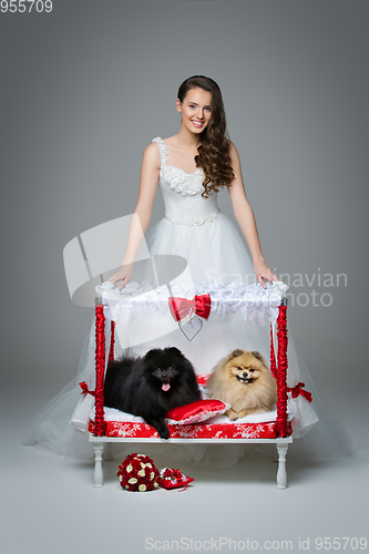 Image of Bride girl with Spitz dog wedding couple on bed