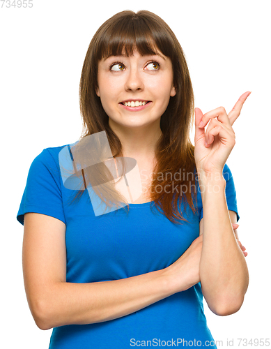 Image of Portrait of a young woman pointing to the right