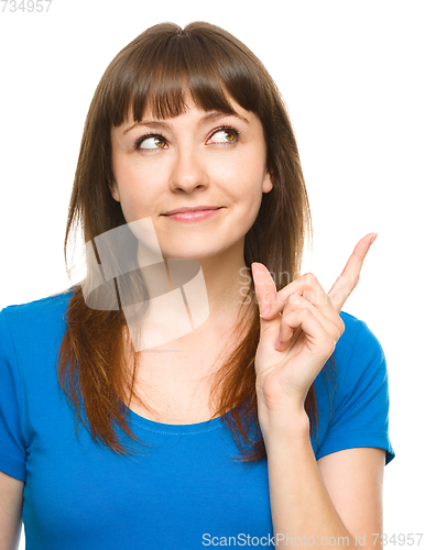Image of Portrait of a young woman pointing to the right
