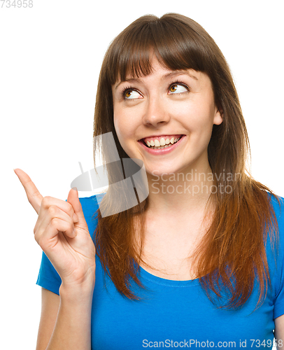 Image of Portrait of a young woman pointing to the left