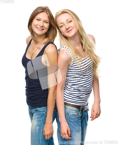 Image of Two young happy women posing