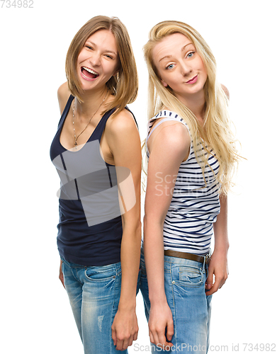 Image of Two young happy women posing