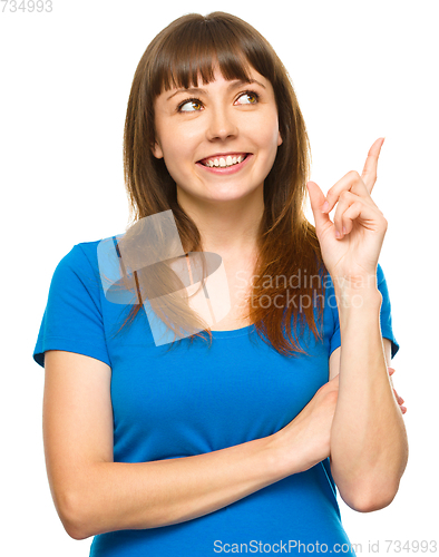 Image of Portrait of a young woman pointing to the right
