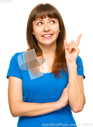 Image of Portrait of a young woman pointing to the right