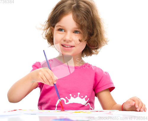 Image of Little girl is painting with gouache