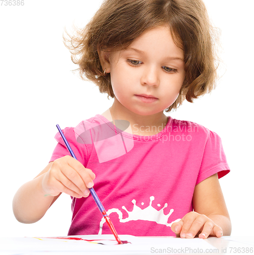 Image of Little girl is painting with gouache