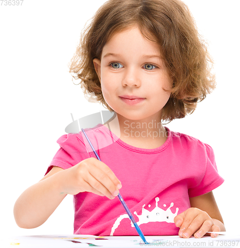 Image of Little girl is painting with gouache